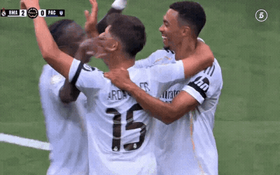 A Group Of Soccer Players Are Hugging Each Other And Celebrating A Goal . GIF