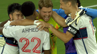 A Group Of Soccer Players Are Hugging Each Other And One Of Them Has The Number 22 On His Back GIF