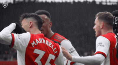 A Group Of Soccer Players Are Hugging Each Other And One Of Them Has The Number 25 On His Back GIF