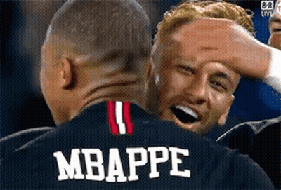 A Group Of Soccer Players Are Hugging Each Other And One Of Them Is Wearing A Jersey With The Name Mbappe On It . GIF