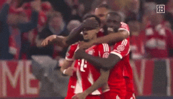 A Group Of Soccer Players Are Hugging Each Other In Front Of A Sign That Says ' Da Zn ' GIF