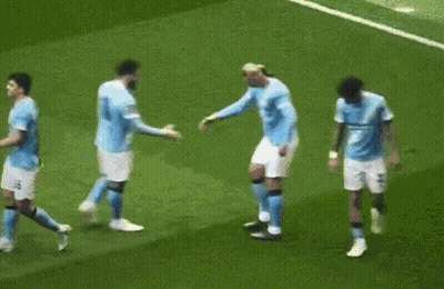 A Group Of Soccer Players Are Hugging Each Other On A Field GIF