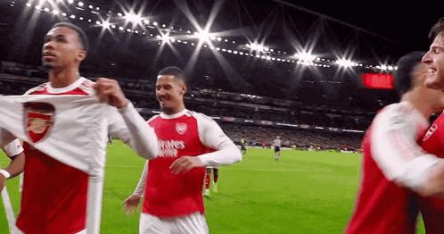 A Group Of Soccer Players Are On A Field And One Of Them Is Wearing A Shirt That Says Fly Emirates GIF
