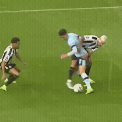 A Group Of Soccer Players Are Playing A Game Of Soccer On A Field . GIF