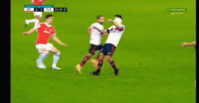 A Group Of Soccer Players Are Playing A Game On A Field . GIF