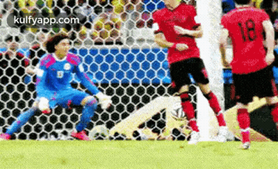 A Group Of Soccer Players Are Playing A Game On A Field . One Of The Players Has The Number 18 On His Shirt . GIF
