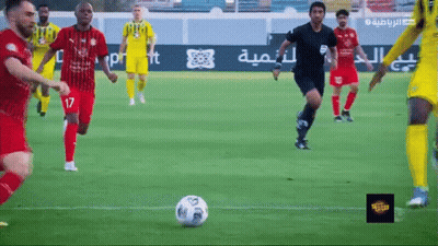 A Group Of Soccer Players Are Playing A Game On A Field With Arabic Writing On The Sidelines GIF
