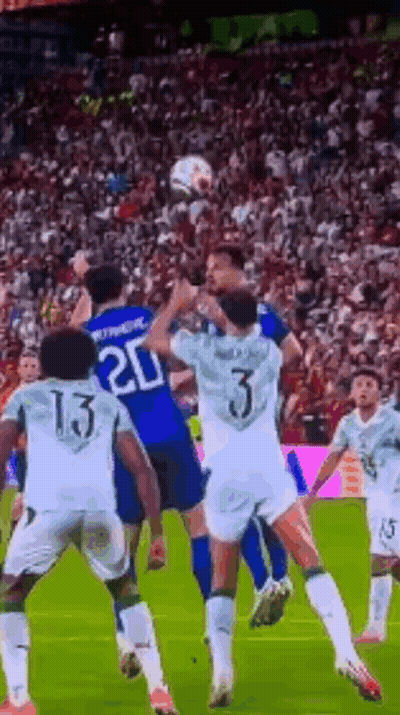 A Group Of Soccer Players Are Playing A Game On A Soccer Field . GIF