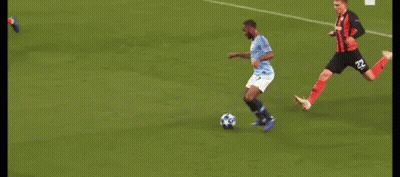 A Group Of Soccer Players Are Playing A Game On A Soccer Field . GIF
