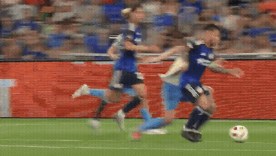 A Group Of Soccer Players Are Playing A Game On A Soccer Field . GIF