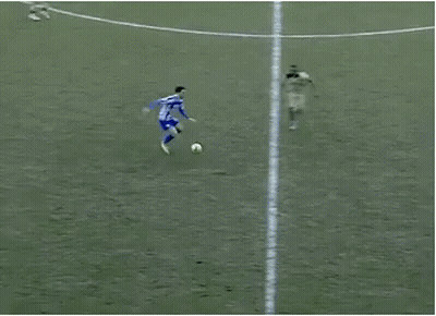 A Group Of Soccer Players Are Playing On A Field And One Of Them Is Wearing A Blue And White Striped Shirt GIF