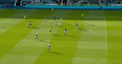A Group Of Soccer Players Are Playing On A Field And One Of Them Is Wearing A Yellow Shirt GIF
