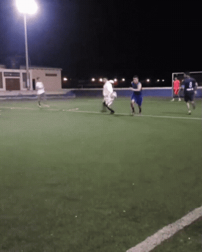 A Group Of Soccer Players Are Playing On A Field At Night And One Of Them Is Wearing A Number 8 Jersey GIF