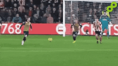 A Group Of Soccer Players Are Playing On A Field . GIF