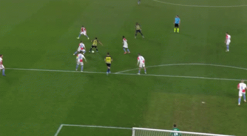 A Group Of Soccer Players Are Playing On A Field With A Goalie GIF
