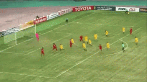 A Group Of Soccer Players Are Playing On A Field With Toyota Advertisements Behind Them GIF