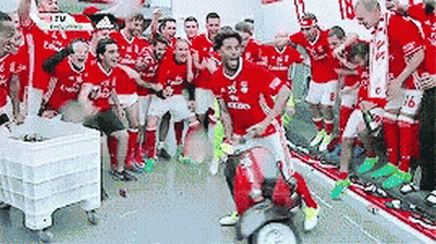 A Group Of Soccer Players Are Posing For A Photo In A Locker Room . GIF