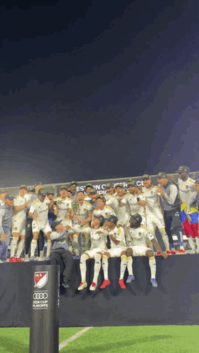 A Group Of Soccer Players Are Posing For A Picture In Front Of A Sign That Says Audi GIF