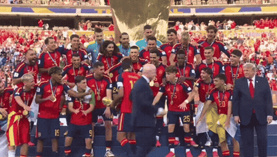 A Group Of Soccer Players Are Posing For A Picture With A Man In A Suit With The Number 20 On His Shirt GIF