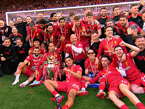 A Group Of Soccer Players Are Posing For A Picture With The Trophy GIF