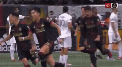 A Group Of Soccer Players Are Running On A Field And One Of Them Has The Number 10 On His Jersey GIF