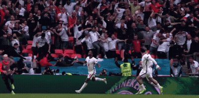 A Group Of Soccer Players Are Running On A Field In Front Of A Heineken Ad GIF