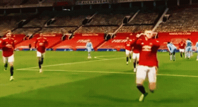 A Group Of Soccer Players Are Running On A Soccer Field In A Stadium . GIF
