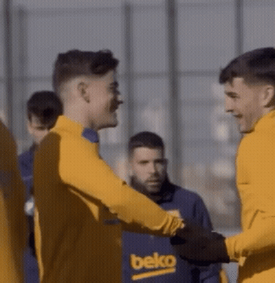 A Group Of Soccer Players Are Shaking Hands While Wearing Yellow Jerseys . GIF