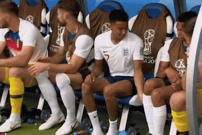 A Group Of Soccer Players Are Sitting In A Locker Room And One Of Them Has The Number 5 On His Jersey GIF
