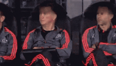 A Group Of Soccer Players Are Sitting In The Dugout Watching A Game . GIF