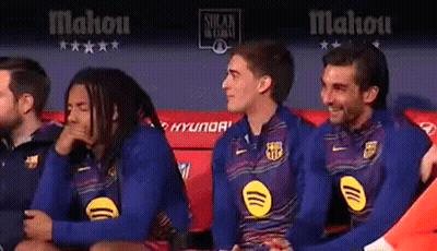 A Group Of Soccer Players Are Sitting On A Bench In A Locker Room . GIF