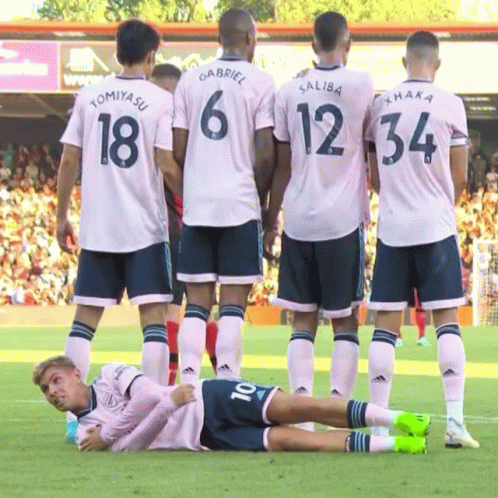 A Group Of Soccer Players Are Standing Around A Player With The Number 10 On His Back GIF