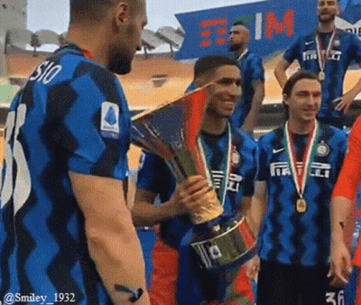 A Group Of Soccer Players Are Standing Around A Trophy And One Has The Number 36 On His Shirt GIF