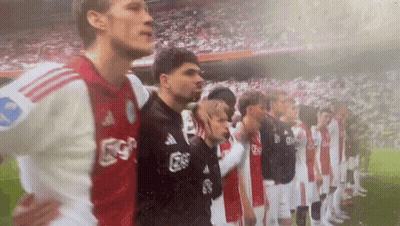 A Group Of Soccer Players Are Standing In A Line On The Field . GIF