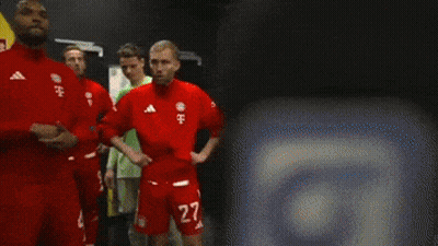 A Group Of Soccer Players Are Standing In A Room With A Yellow Wall That Says Vodafone GIF