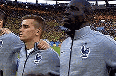 A Group Of Soccer Players Are Standing In A Stadium . GIF