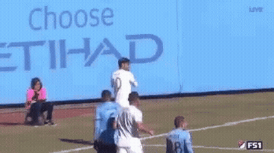 A Group Of Soccer Players Are Standing In Front Of A Blue Background . GIF