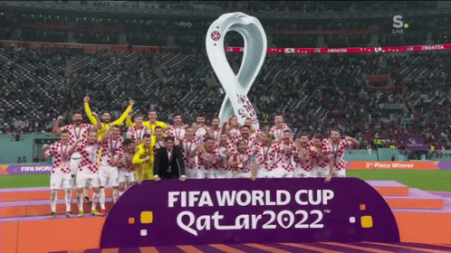 A Group Of Soccer Players Are Standing In Front Of A Sign That Says Fifa World Cup Qatar2022 GIF