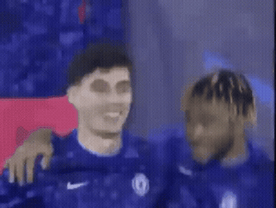 A Group Of Soccer Players Are Standing Next To Each Other And One Of Them Is Smiling . GIF