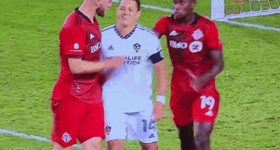 A Group Of Soccer Players Are Standing Next To Each Other On A Soccer Field . GIF