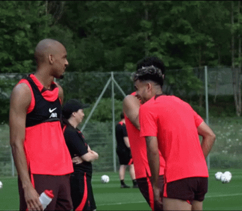 A Group Of Soccer Players Are Standing On A Field And One Of Them Is Wearing A Vest That Says Nike GIF
