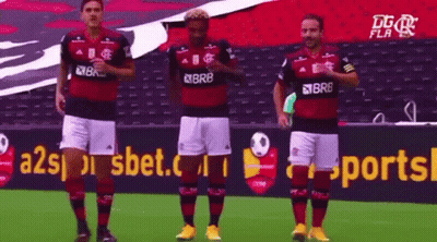 A Group Of Soccer Players Are Standing On A Field In Front Of A Sports Advertisement . GIF