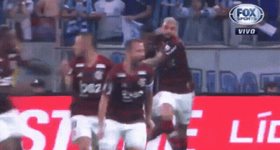 A Group Of Soccer Players Are Standing On A Field . GIF