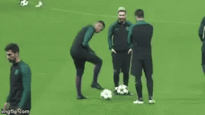 A Group Of Soccer Players Are Standing On A Field With Balls . GIF
