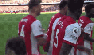 A Group Of Soccer Players Are Standing On A Field With One Wearing The Number 5 GIF