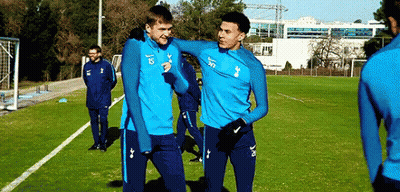 A Group Of Soccer Players Are Standing On A Soccer Field . GIF