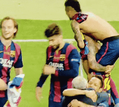 A Group Of Soccer Players Are Standing On Top Of Each Other On A Field . GIF