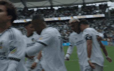 A Group Of Soccer Players Are Walking On A Field With A Banner Behind Them That Says " Global " GIF