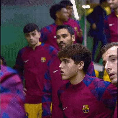 A Group Of Soccer Players Are Wearing Nike Jackets With The Fcb Logo On Them GIF