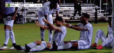 A Group Of Soccer Players Celebrate A Goal During A Match Between Por And Cin GIF
